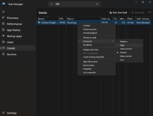 Task Manager showing running processes.
